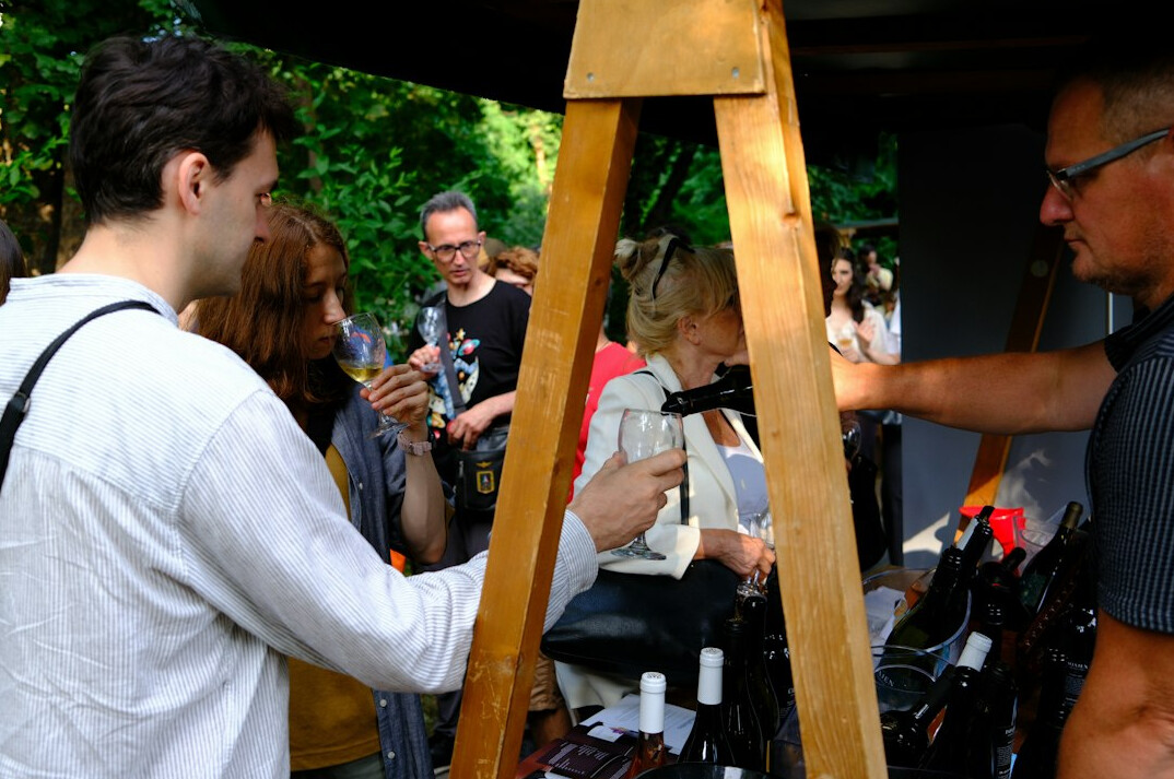 Professional broadcast camera on a tripod filming an outdoor news event
