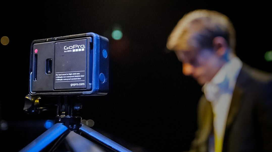 Camera operator filming a news presenter during a live television broadcast